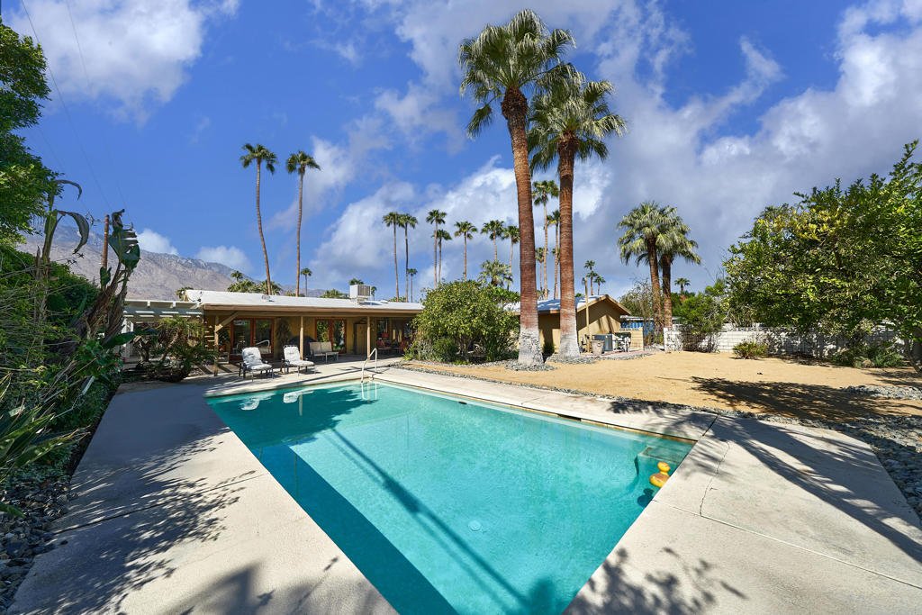Backyard pool with tall palms at a Cathedral City home