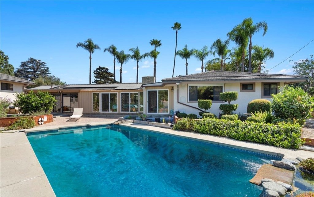 Quiet home pool with tall palms during pool leak detection in Campanile