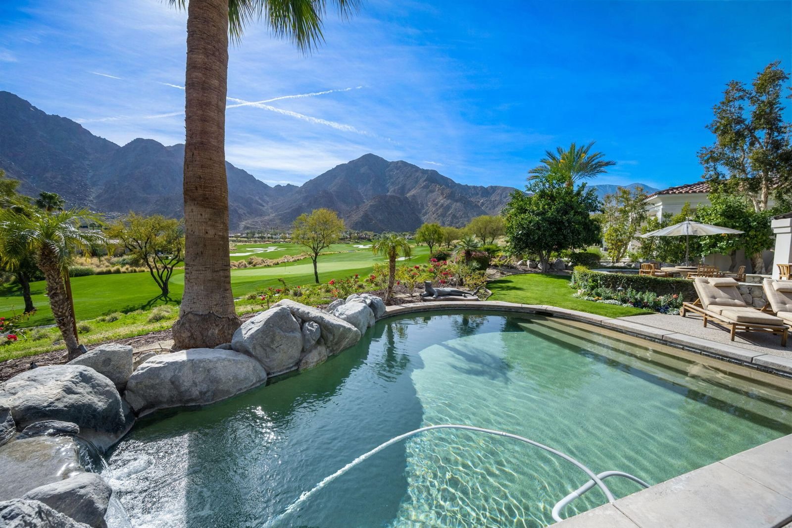 Pool overlooking a golf course at a home in Cathedral Canyon Country Club