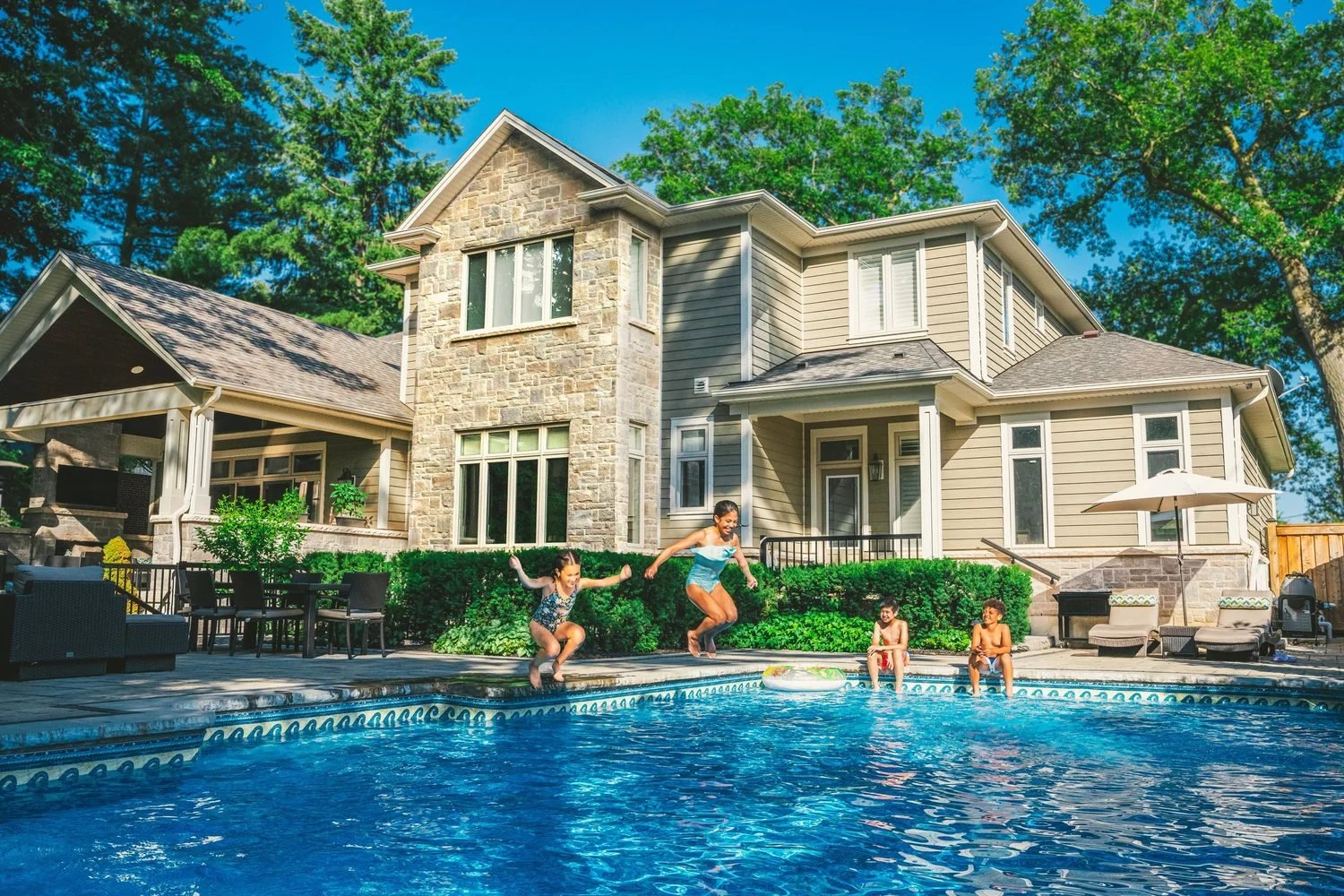 Kids jumping into a family pool during pool leak detection in Century Park