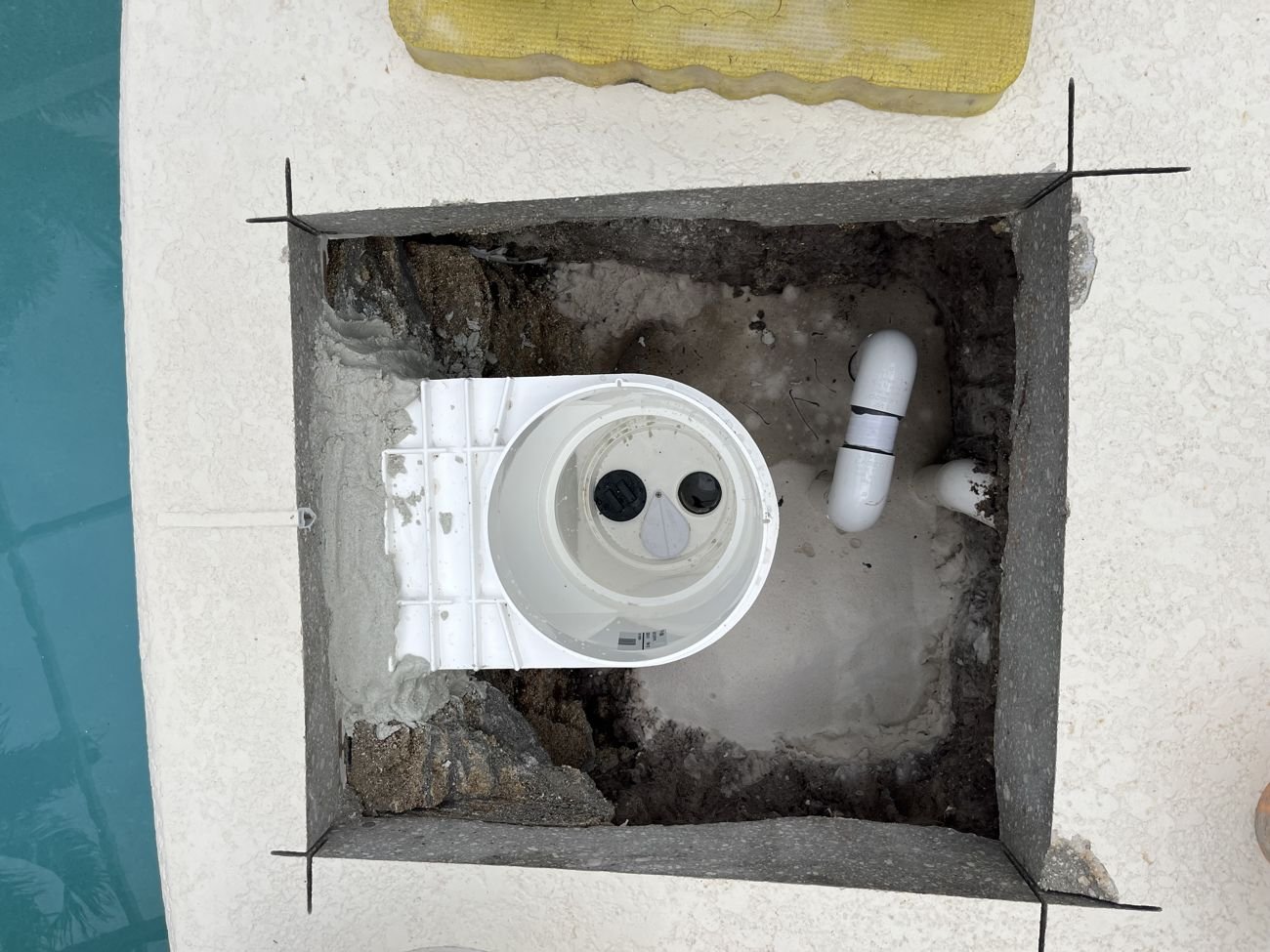 New skimmer body set into a deck opening during a repair in Cathedral City