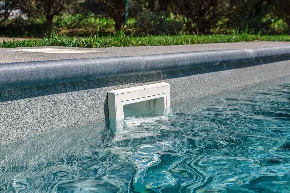 Pool skimmer mouth at the water line during pool skimmer leak repair in Cathedral City