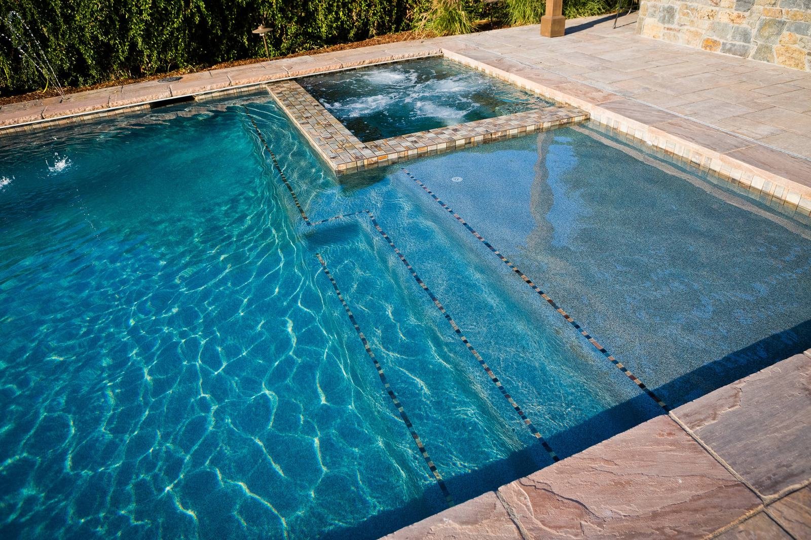 Pool with a raised spa during spa leak detection in Cathedral City